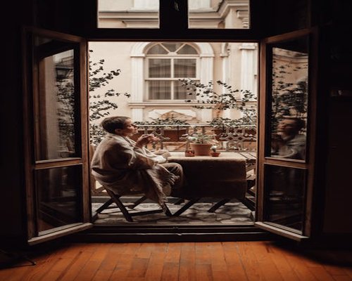 Person enjoying morning coffee by the window, practicing visual rest